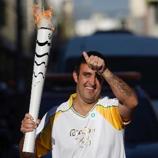 Andre Akkari with the Olympic Torce